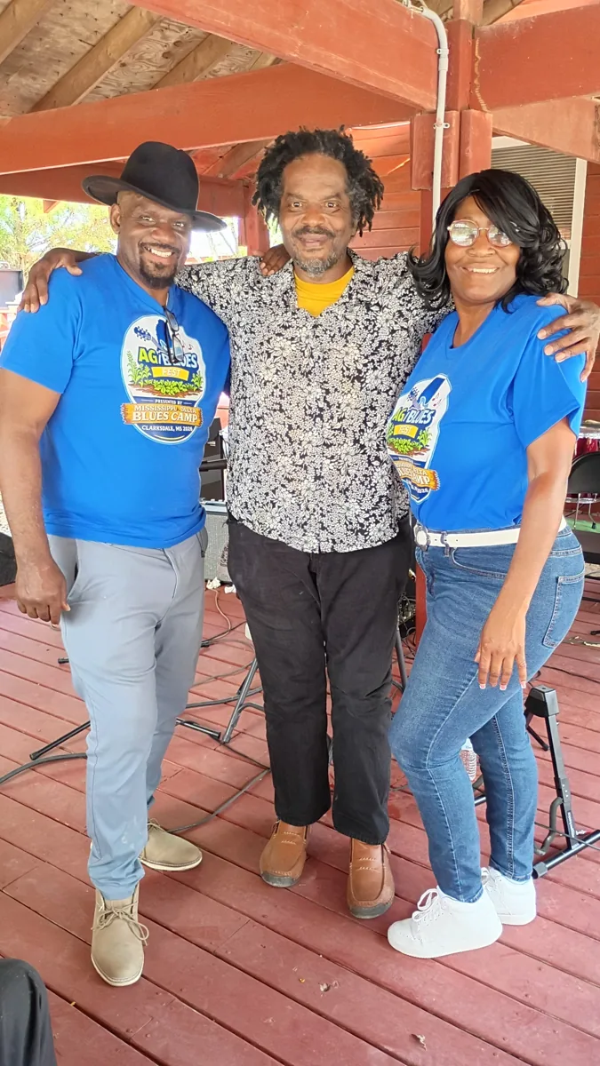 Three visitors standing together on the farm deck
