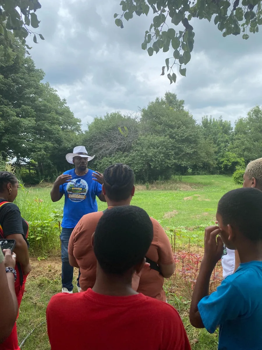 Visitors listening during an outdoor farm tour