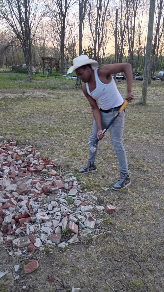 Person raking leaves on the grounds at Young Family Farm