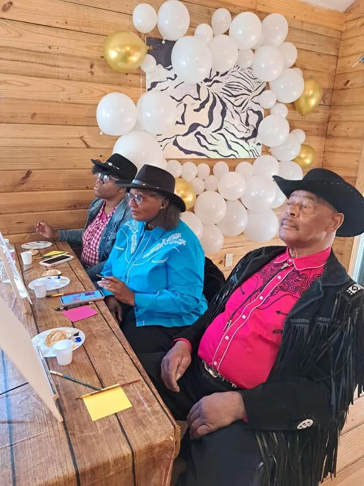 Western-themed painting gathering with a balloon backdrop